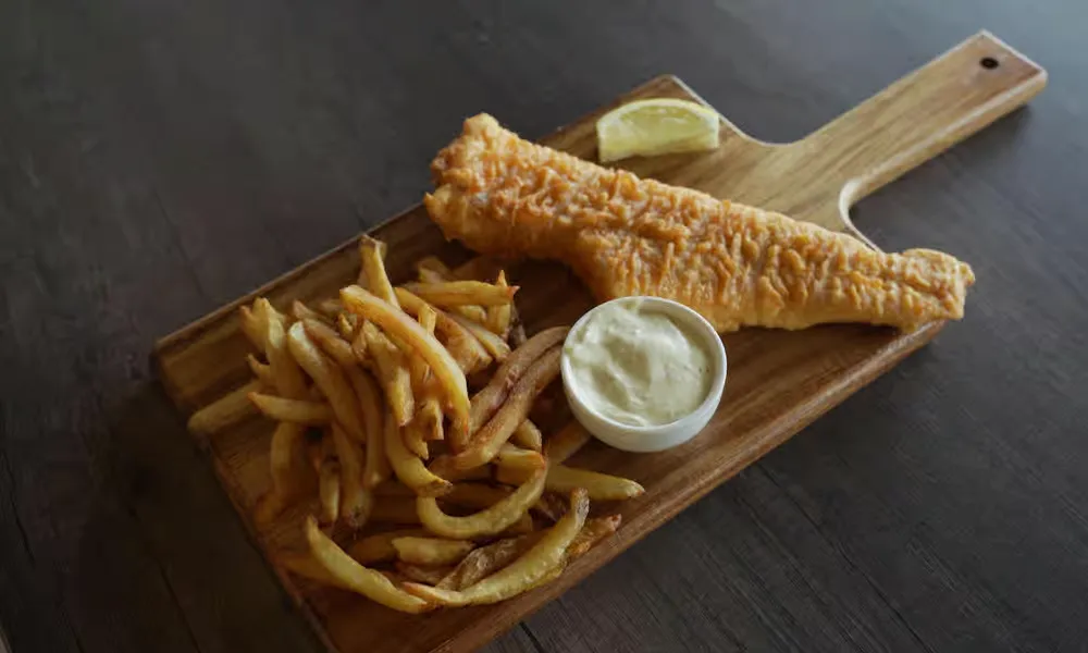Golden battered cod and chips at Jackson Heights Fish And Chips Winnipeg - flaky cod in a golden batter with hand-cut fries and lemon
